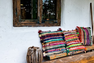multi colored textile on brown wooden window