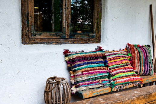 multi colored textile on brown wooden window