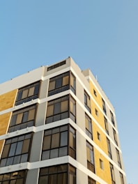 Exterior view of a modern commercial building freshly painted in neutral tones.