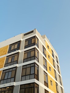 Exterior view of a modern commercial building freshly painted in neutral tones.