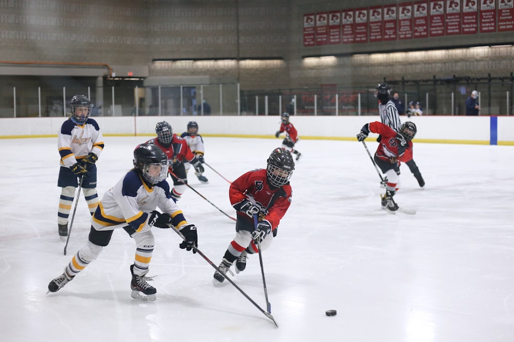 men playing ice hockey on ice stadium