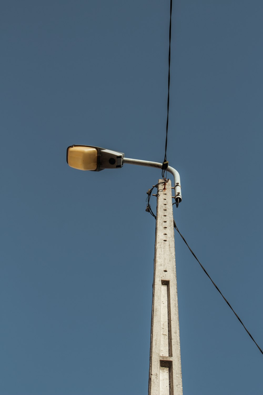 brown and white street light under blue sky during daytime