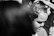 A close-up of a sharp fade haircut under moody lighting, highlighting the barber's skill.
