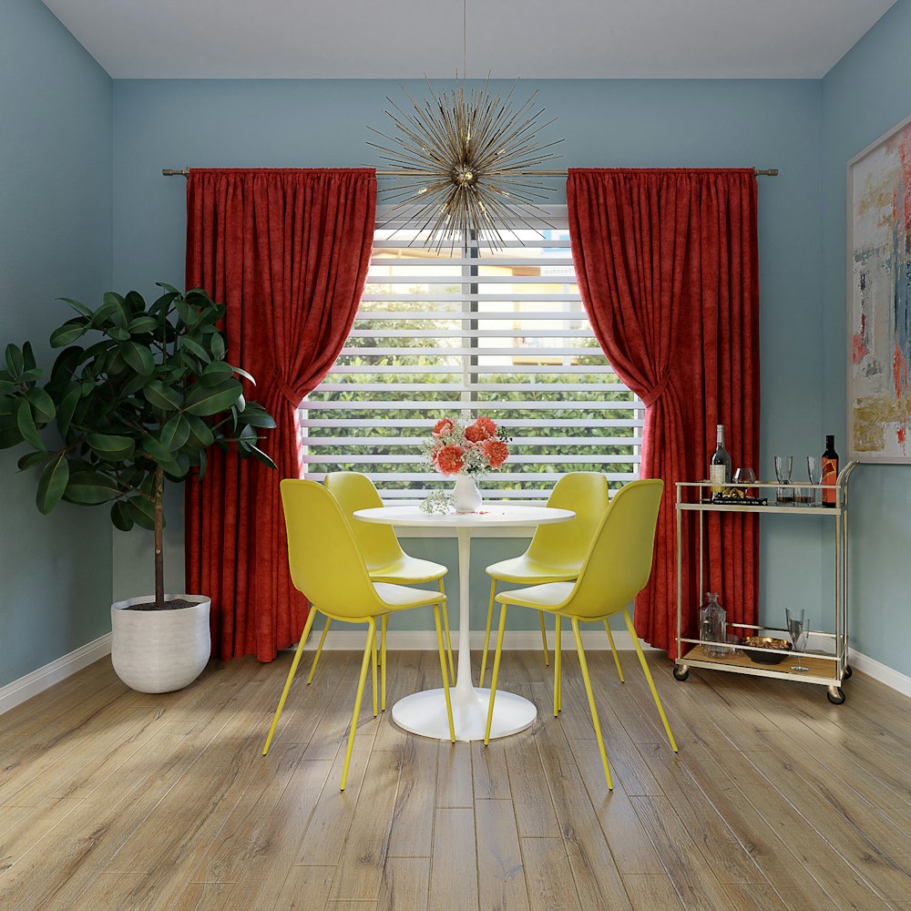 red and yellow chairs near red window curtain