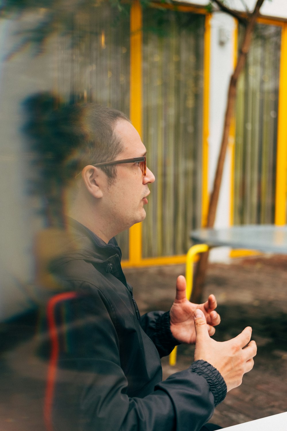 man in black suit jacket wearing eyeglasses