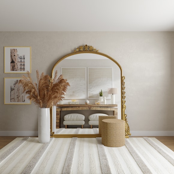 beige wall with large decorative floor mirror and rug