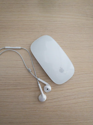 A variety of computer accessories including keyboards, mice, and headphones on a clean surface.