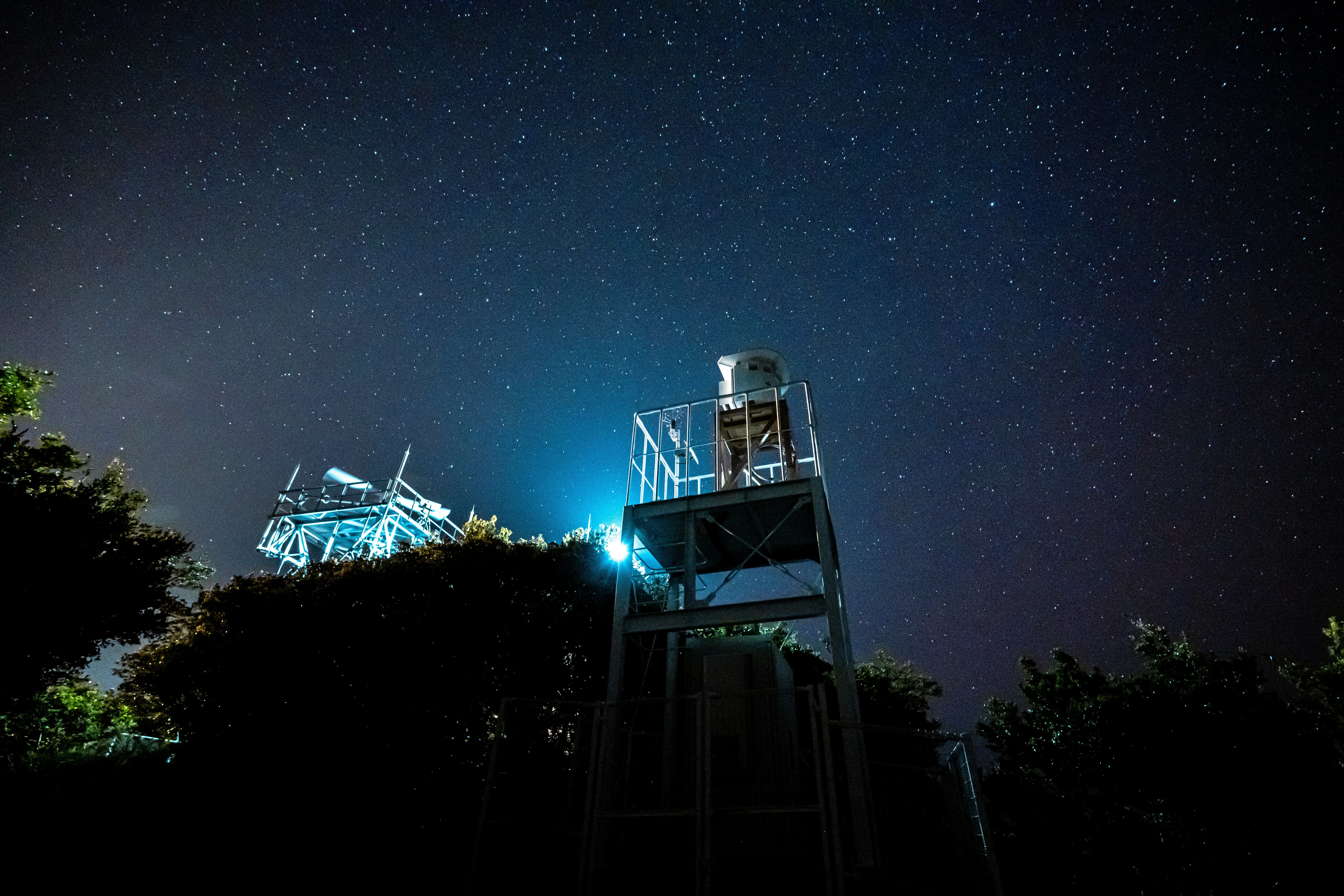 white and black tower under blue sky during night time