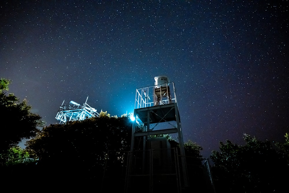 white and black tower under blue sky during night time