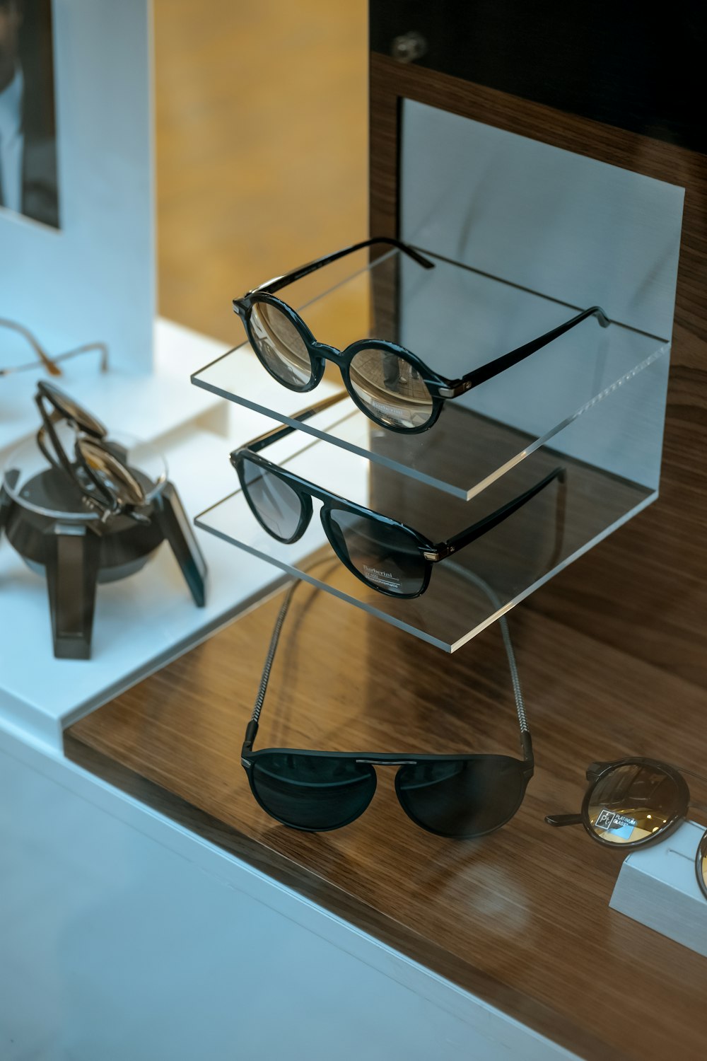 black framed sunglasses on glass shelf