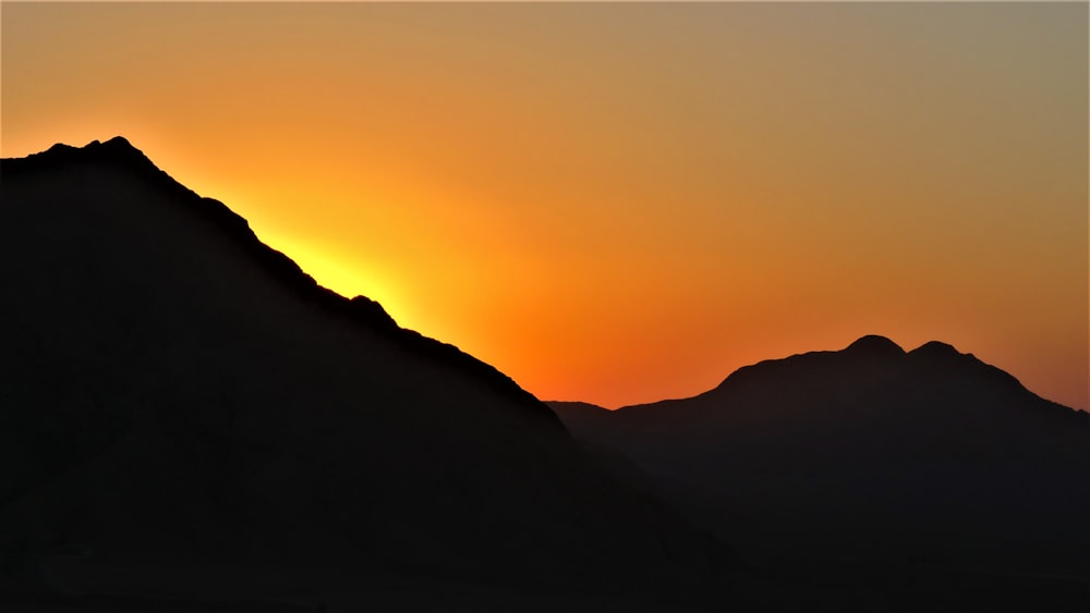 silhouette of mountain during sunset