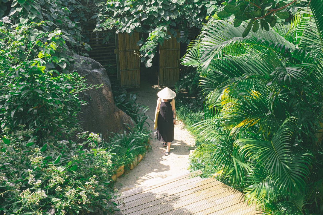 woman in white dress walking on wooden pathway