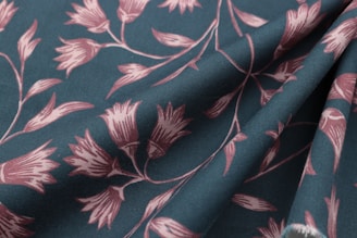 Elegant draped fabric featuring a subtle floral pattern in earthy tones.