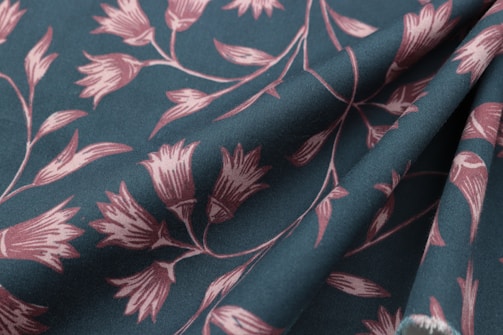 Elegant draped fabric featuring a subtle floral pattern in earthy tones.