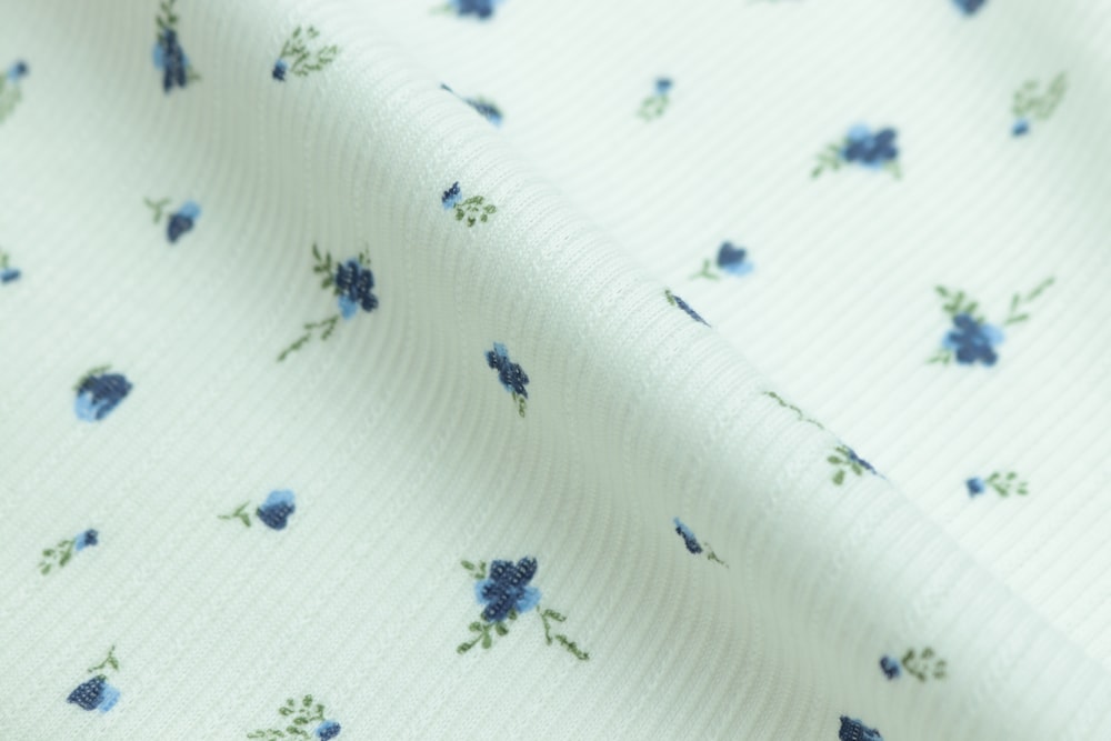 white and blue floral textile