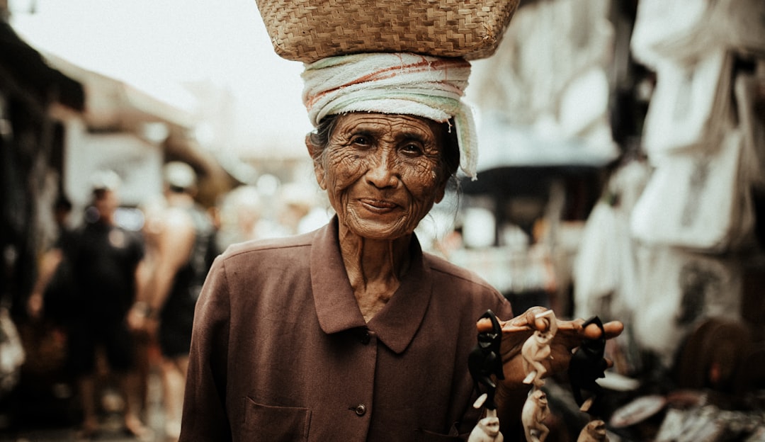 man in brown hat and brown coat holding brown wooden stick