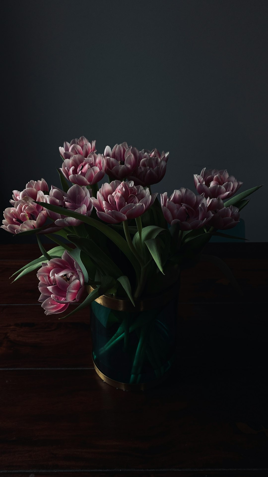 pink flowers on blue glass vase