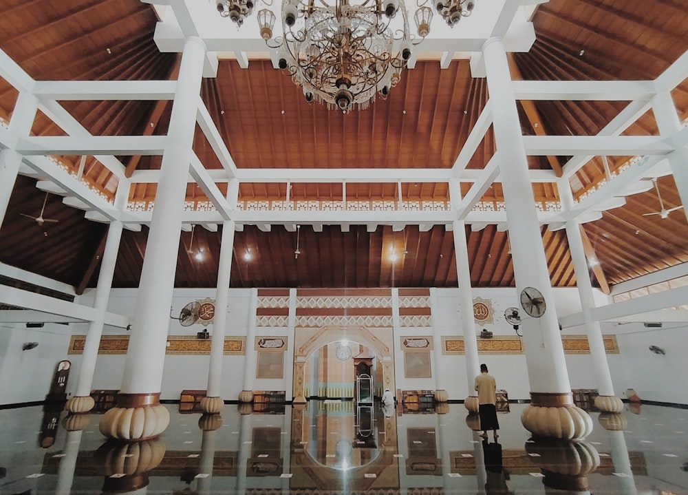 white and gold chandelier on brown wooden ceiling