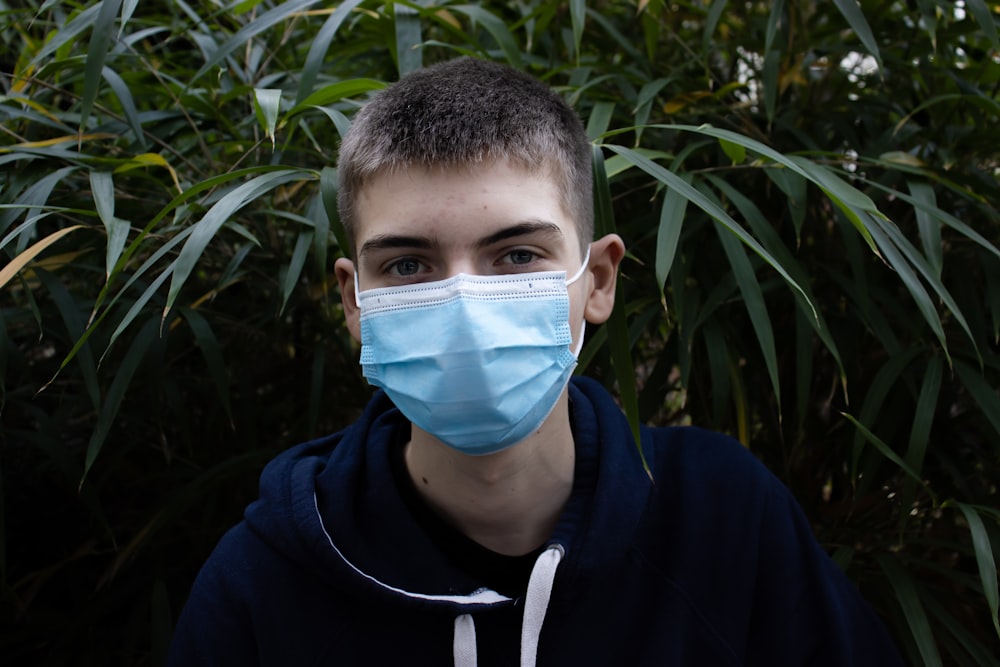 boy in blue and white nike hoodie with blue face mask photo – Free  Nederland Image on Unsplash