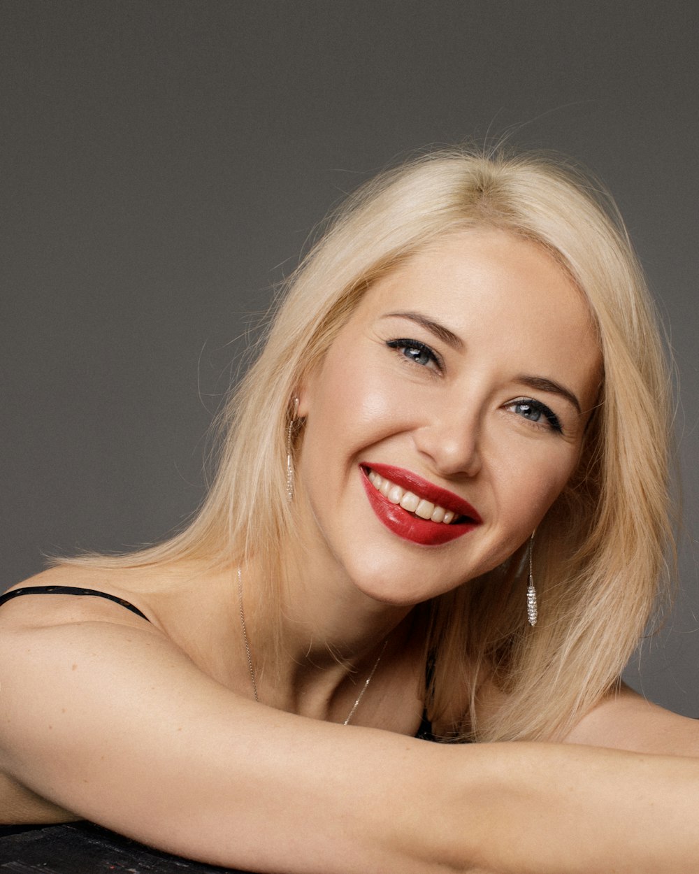 woman in red lipstick smiling