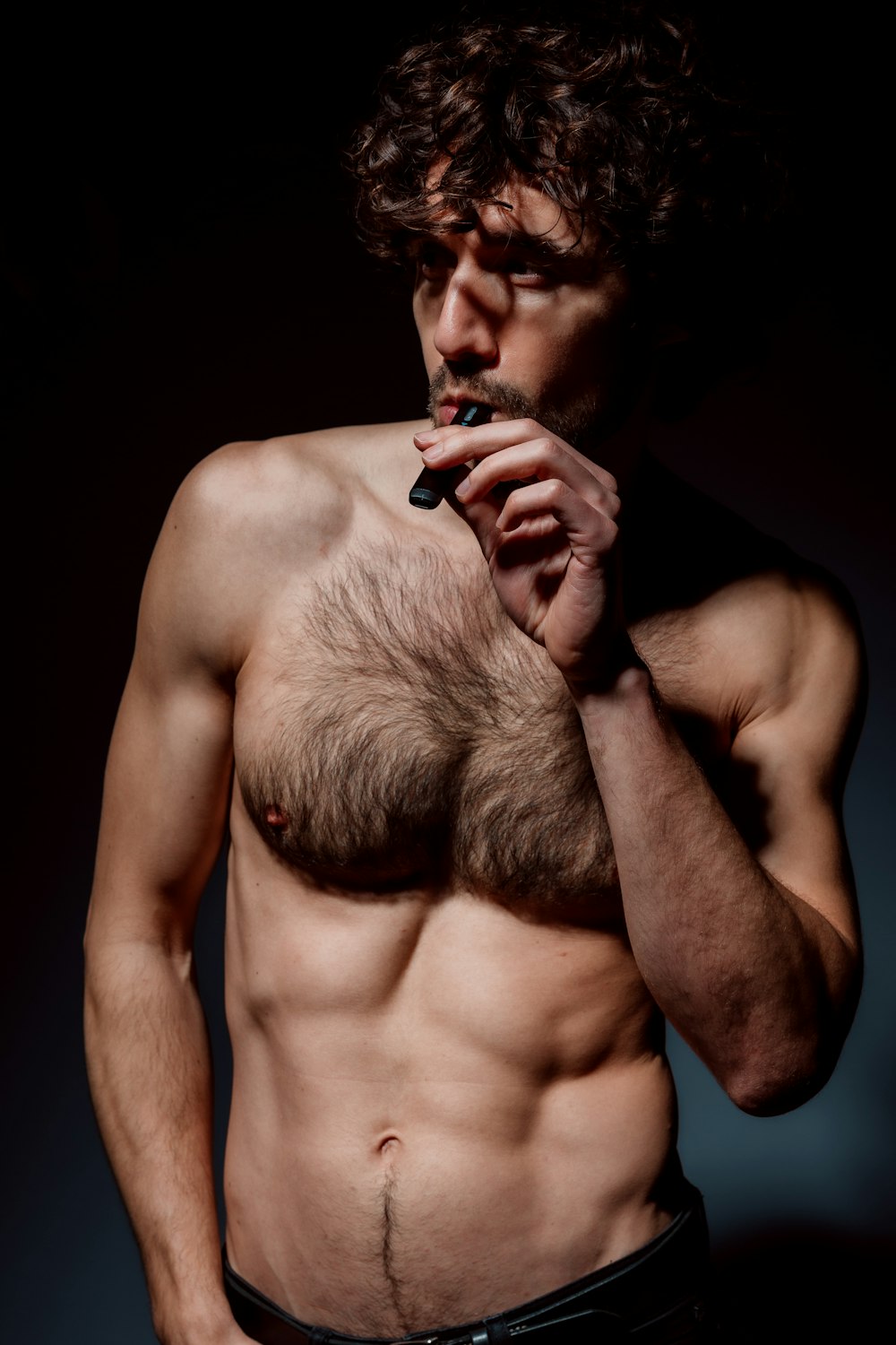 topless man smoking cigarette stick