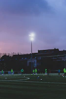 A sports team mid-game, their custom Easy Print Tees bright and bold under the stadium lights.