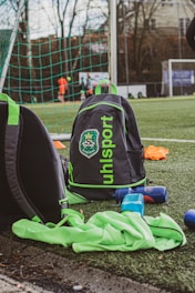 black and orange backpack on green grass field