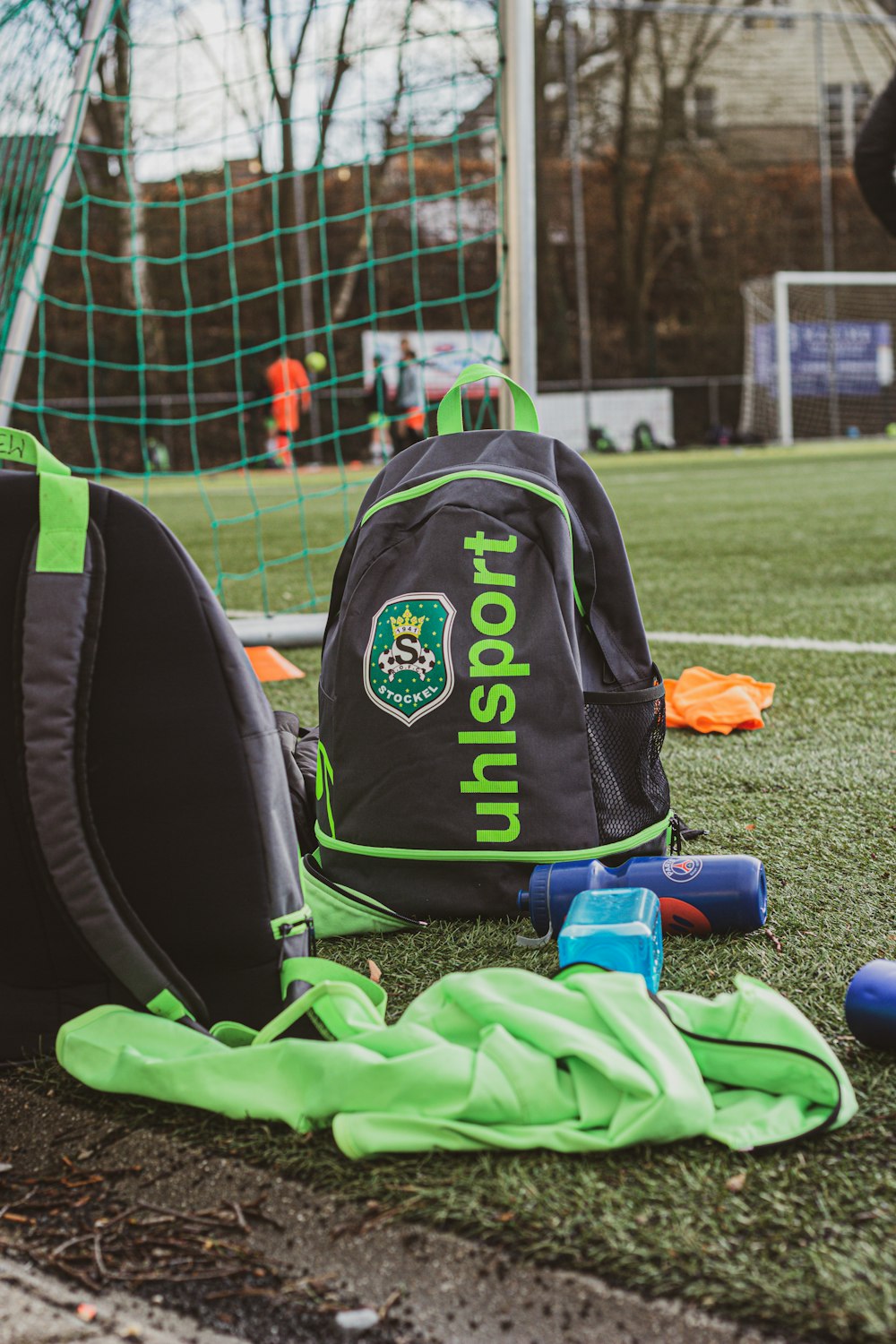 Mochila negra y naranja en campo de hierba verde