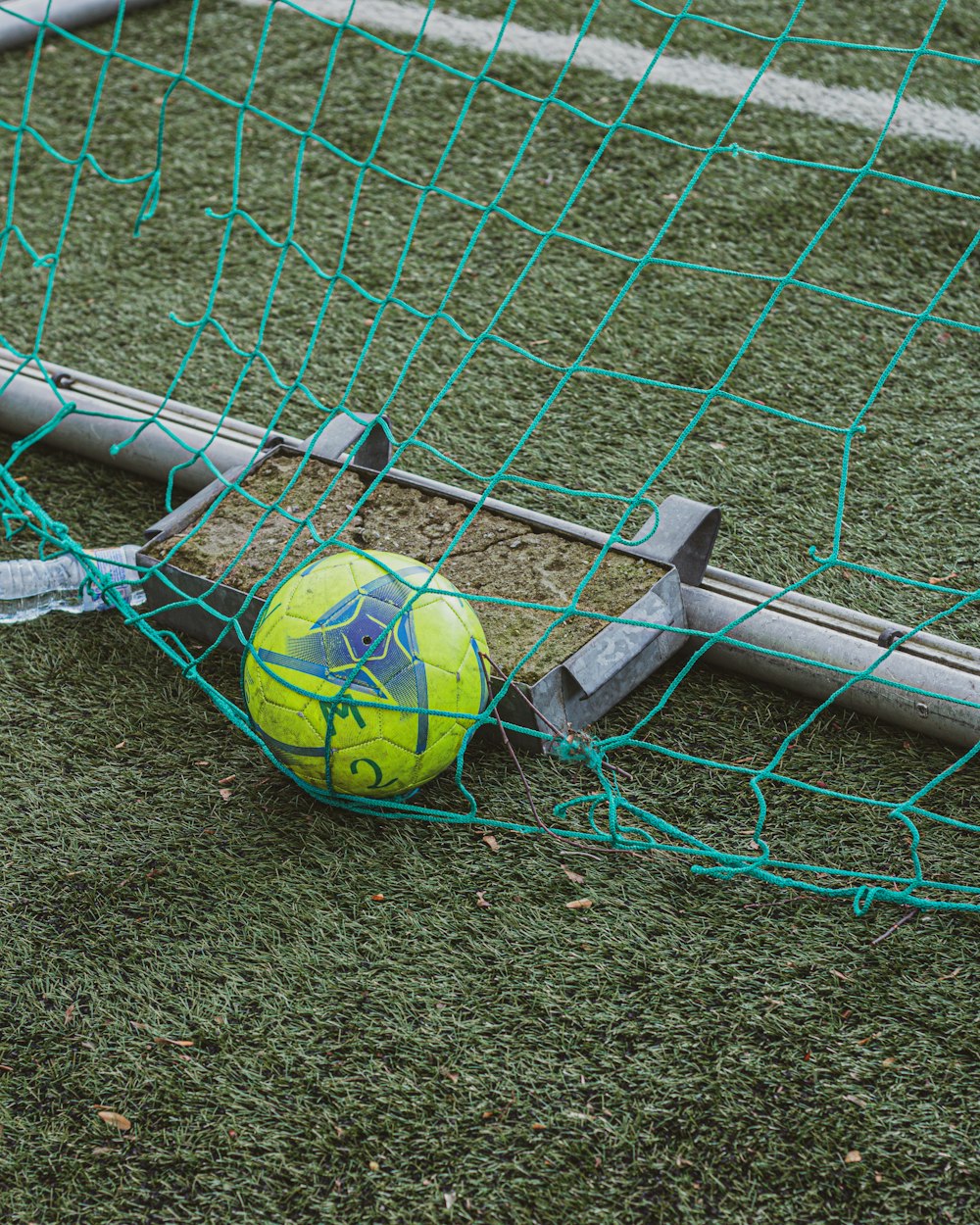 green soccer ball on green grass field
