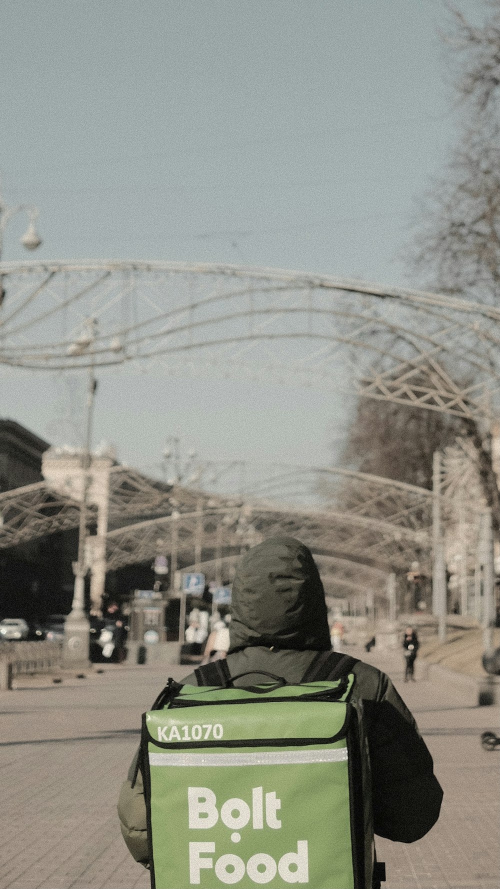 person in black hoodie standing near ferris wheel during daytime