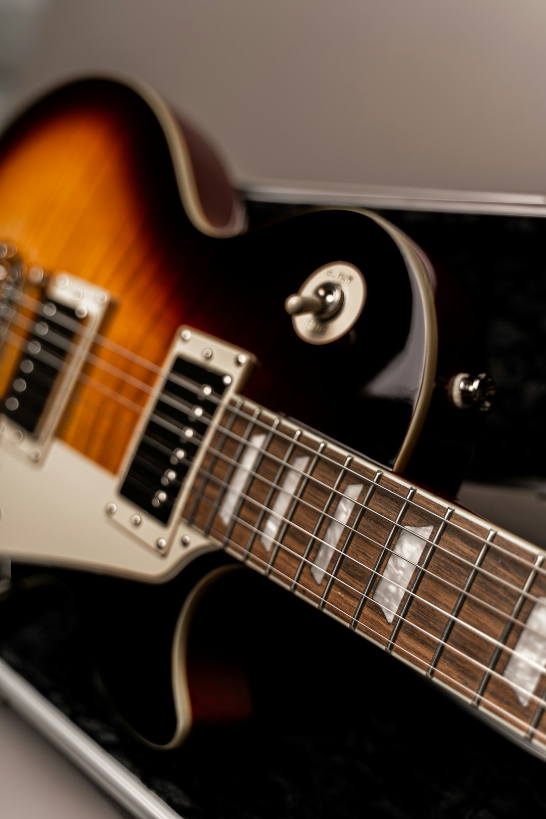 white and brown electric guitar