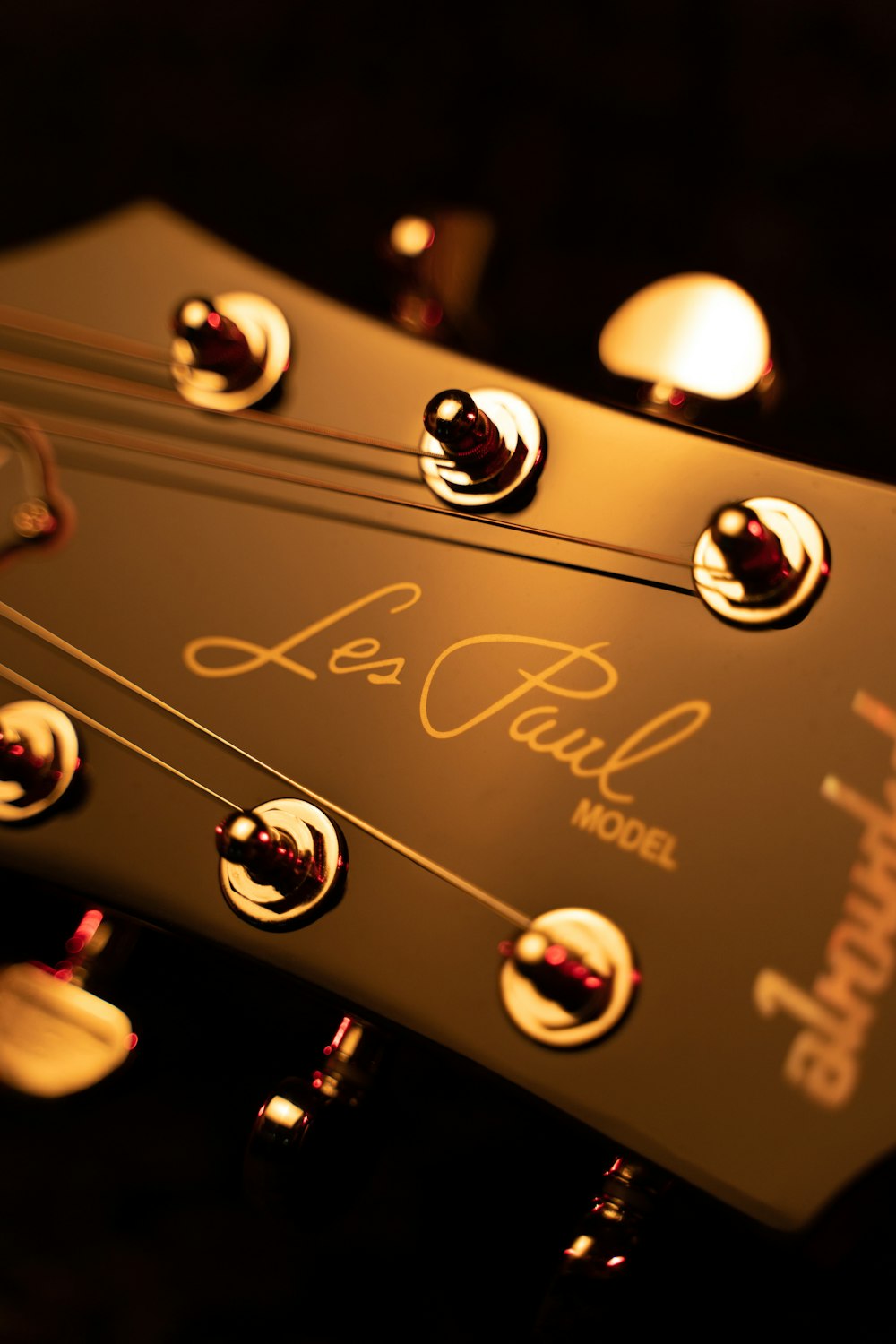 brown guitar headstock in close up photography