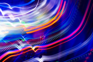 A vibrant digital artwork featuring swirling lines and bursts of color, capturing movement and light.