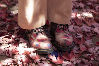 person wearing black and pink floral boots