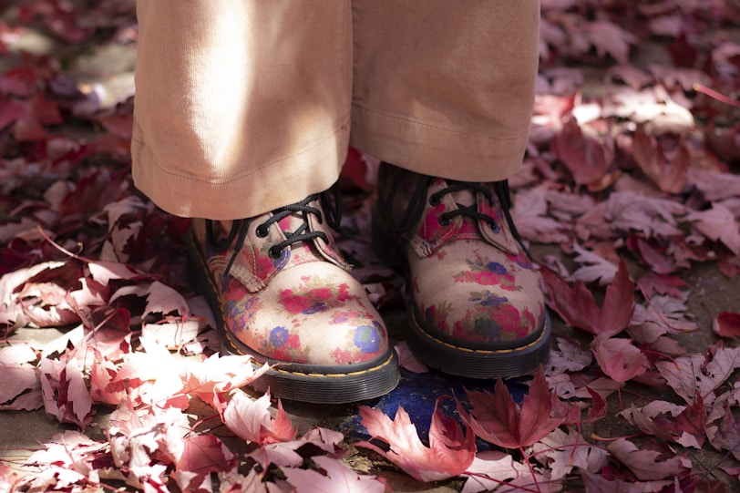 person wearing black and pink floral boots