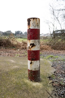 a snowplow-damaged mailbox post next to a newly installed breakaway post meeting ODOT standards