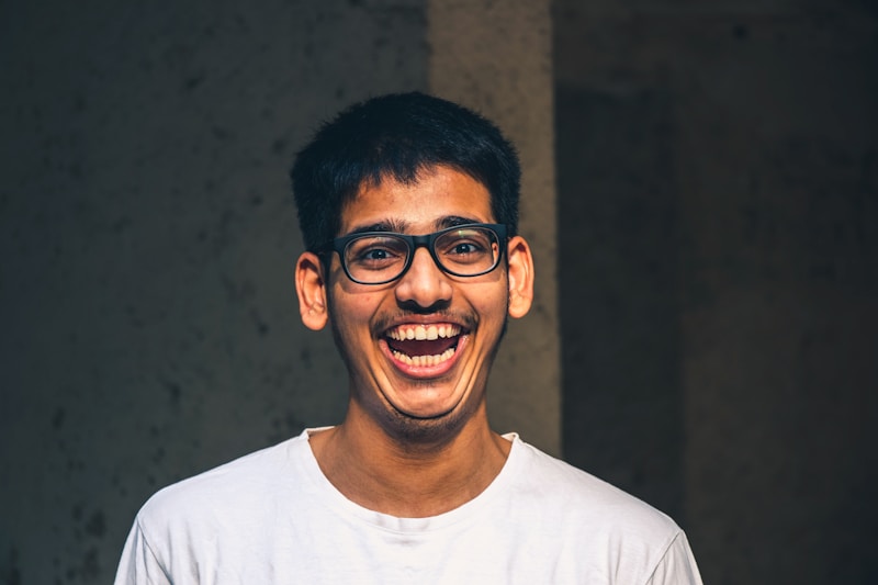 man in white crew neck shirt wearing black framed eyeglasses