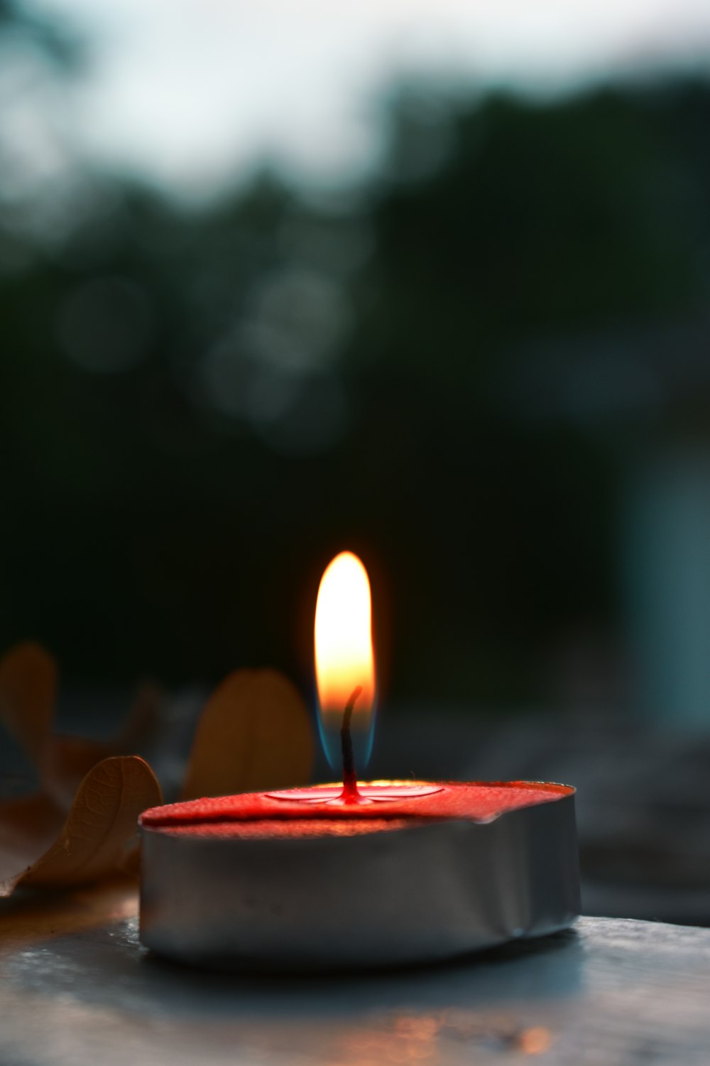 lighted candle on black surface