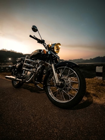 Motorcycle equipped with a powerful HID conversion kit, illuminating a winding road at dusk.