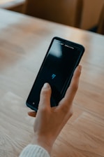 person holding black android smartphone