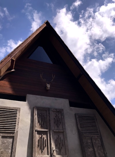 A freshly framed single-family home standing tall against a clear Montana sky, showcasing sturdy wooden beams and precise craftsmanship.