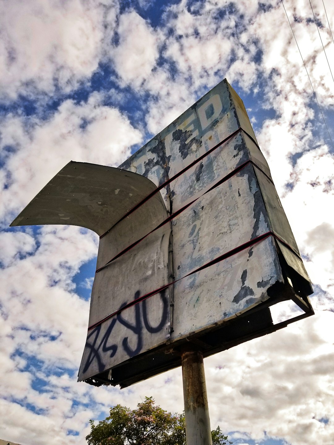 gray and white wooden signage under blue sky during daytime