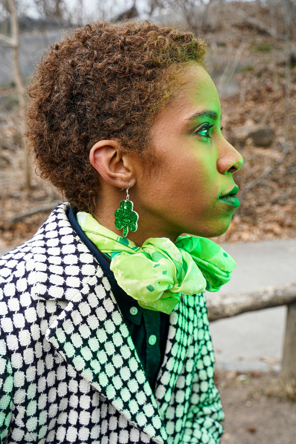 woman in black and white shirt with green scarf