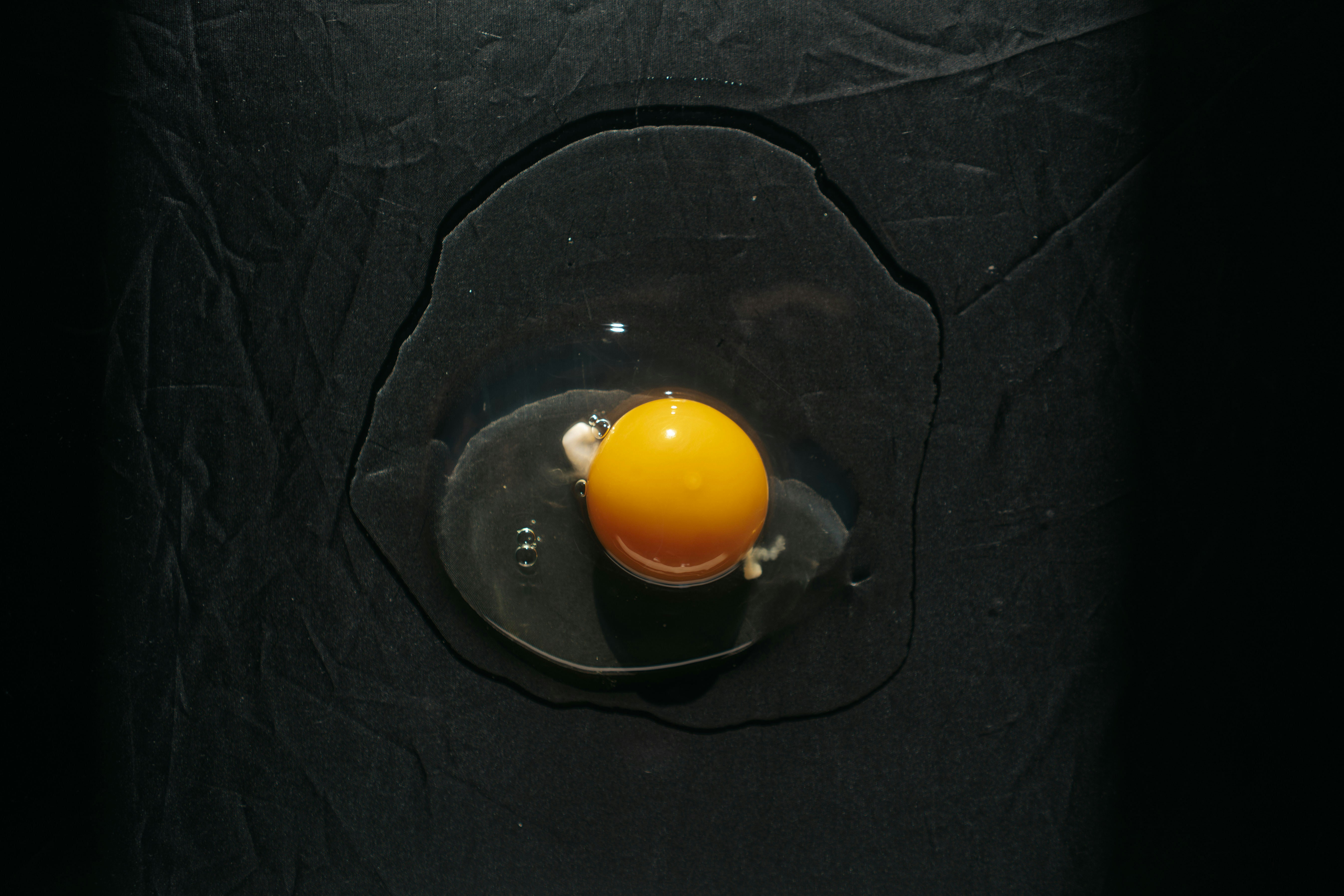 orange plastic round container on black table