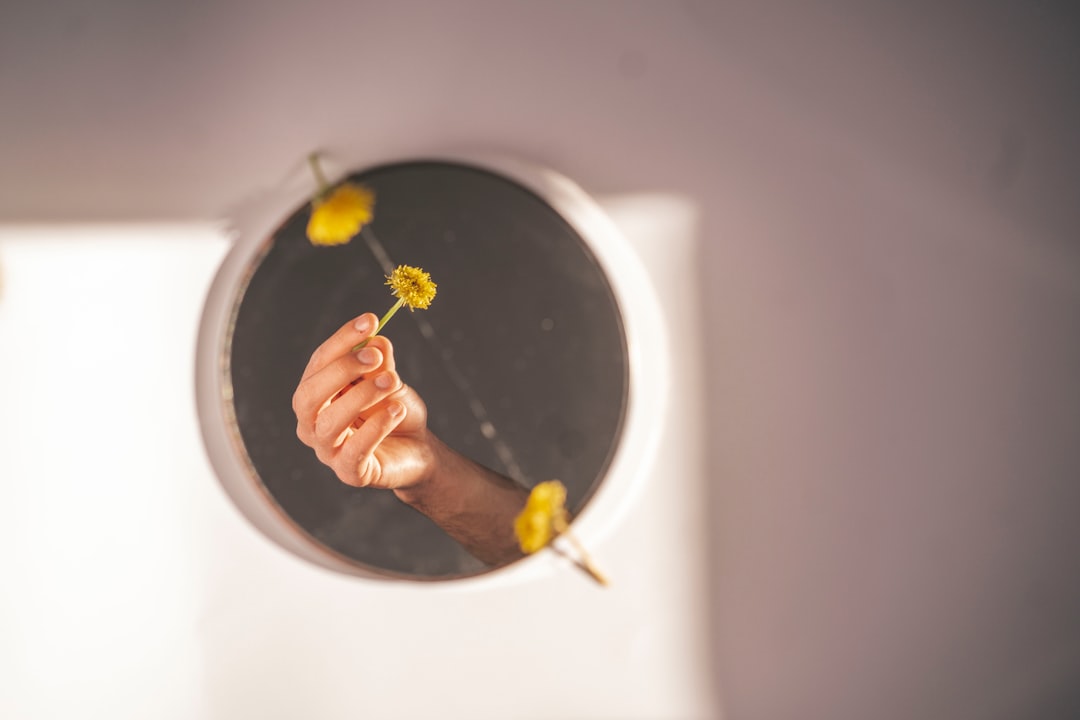 person holding white ceramic plate with black powder