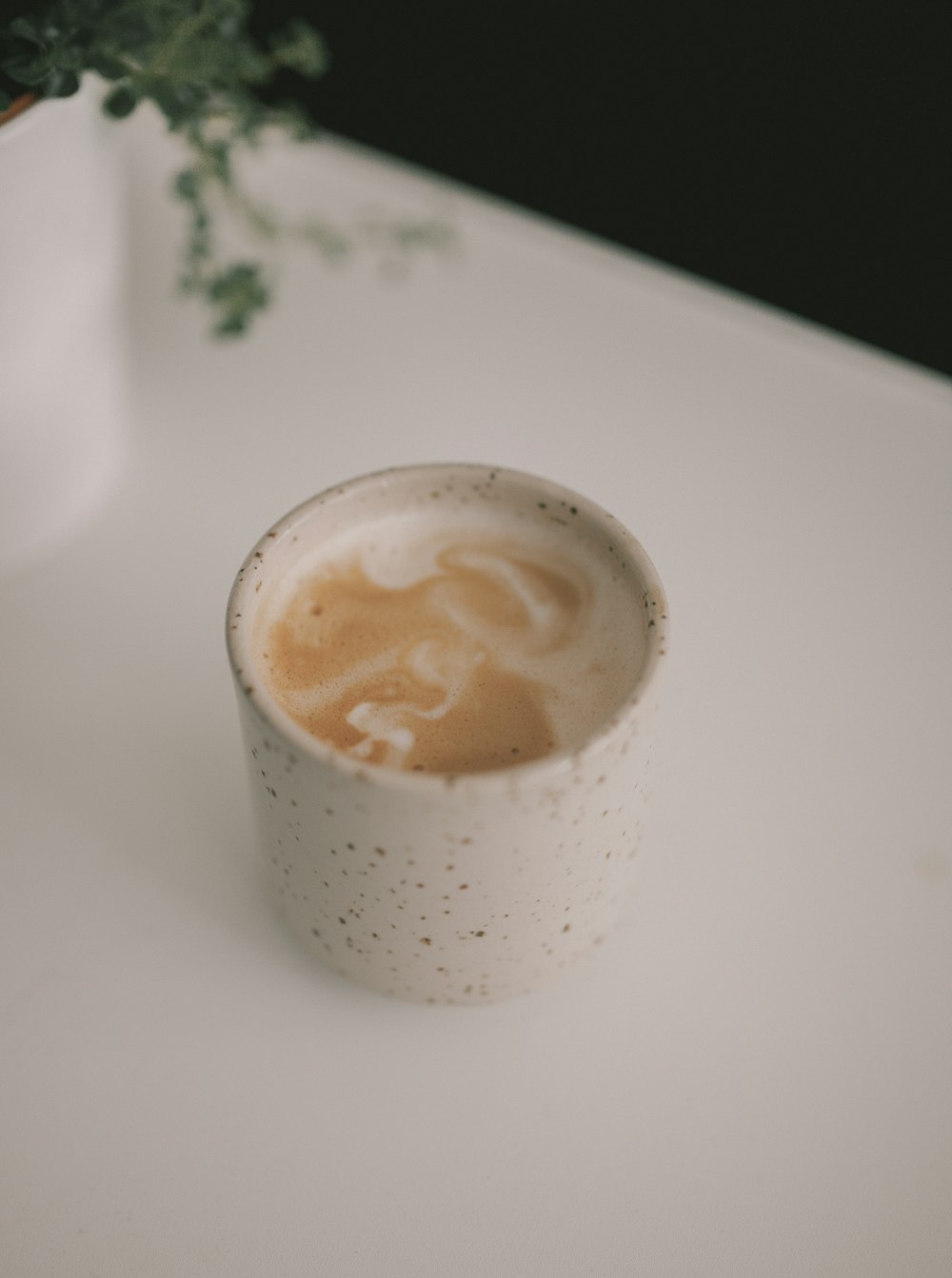 white ceramic cup with brown liquid