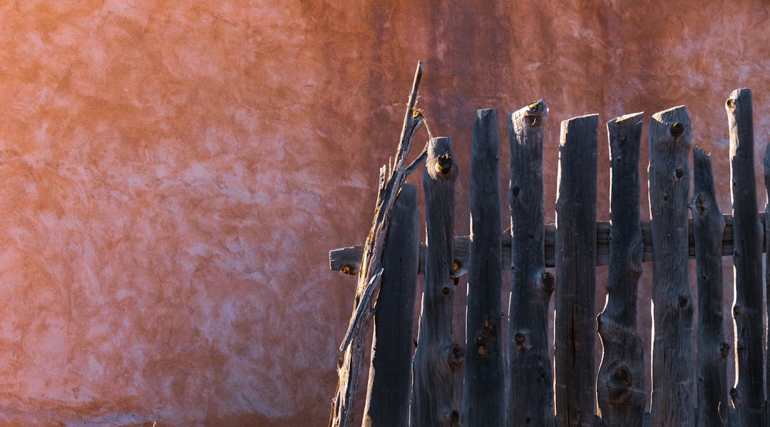 black wooden fence on brown sand