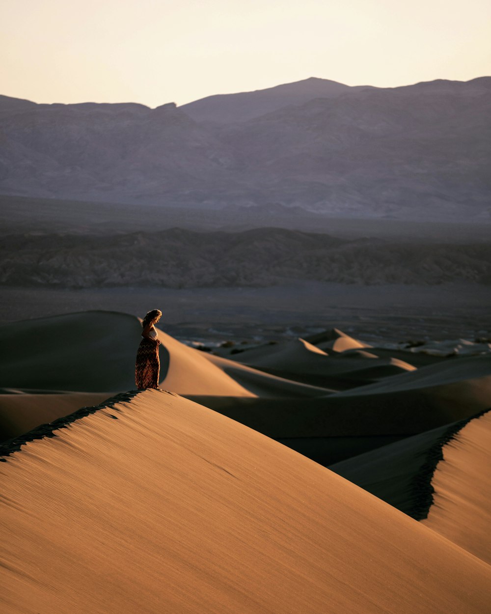 person lying on brown sand during daytime