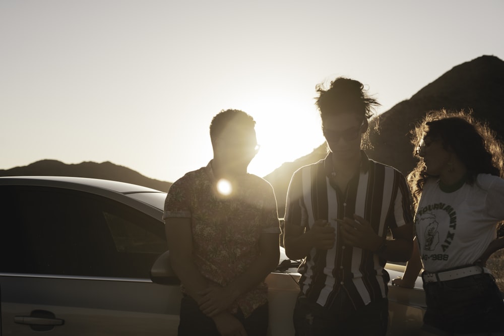 3 women sitting on car