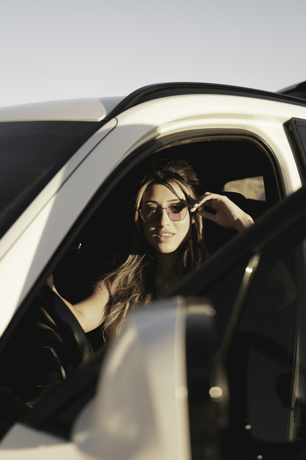 woman in black leather jacket wearing black sunglasses